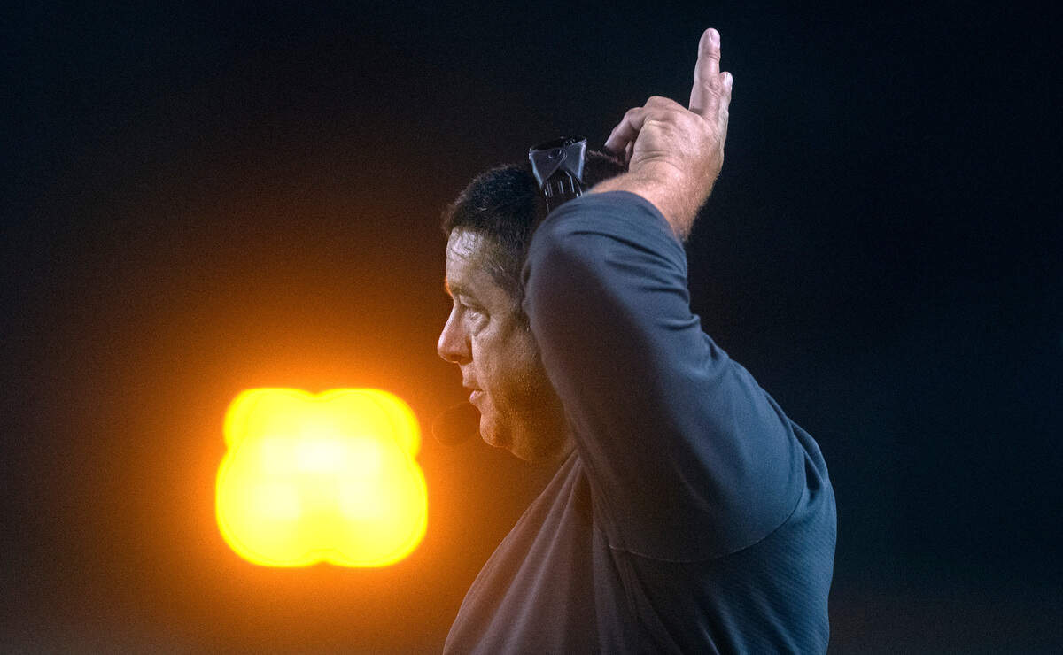 Tumwater defensive coordinator Tim Otton signals in a defense during Friday night’s 2A football game against the North Kitsap Vikings at Tumwater District Stadium in Tumwater, Washington, on Sept. 9, 2022. Tumwater won the game, 8-6.