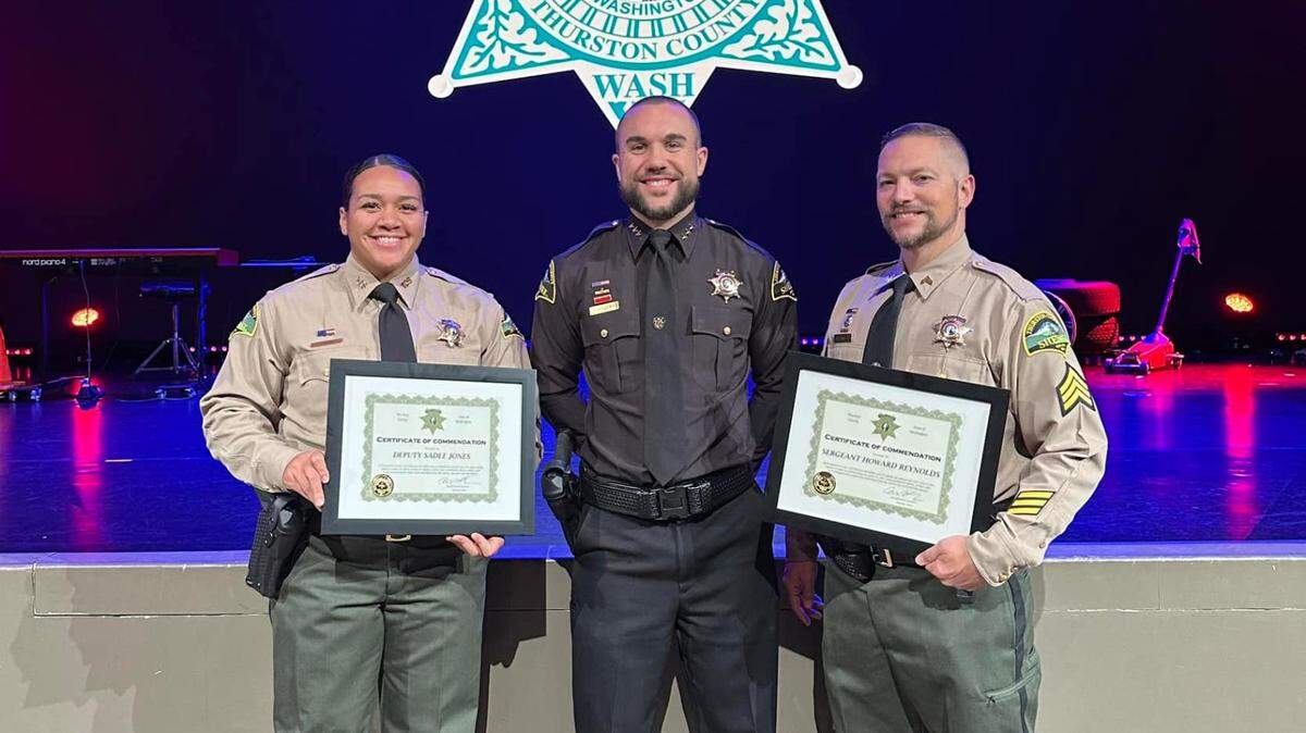 Thurston County Sheriff’s Office Deputy Sadee Jones and Sgt. Howard Reynolds received commendations for helping an elderly resident over the summer. Sheriff Derek Sanders stands between them.