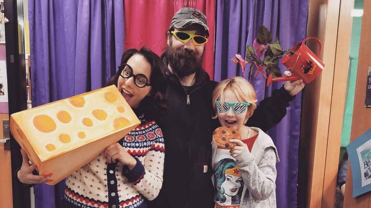 Amy Shephard gets in the holiday spirit at the 2017 Olympia Regional Learning Academy Winter Market with partner Andy Geertsen and his son Alex Geertsen, now 13 and in eighth grade at ORLA.