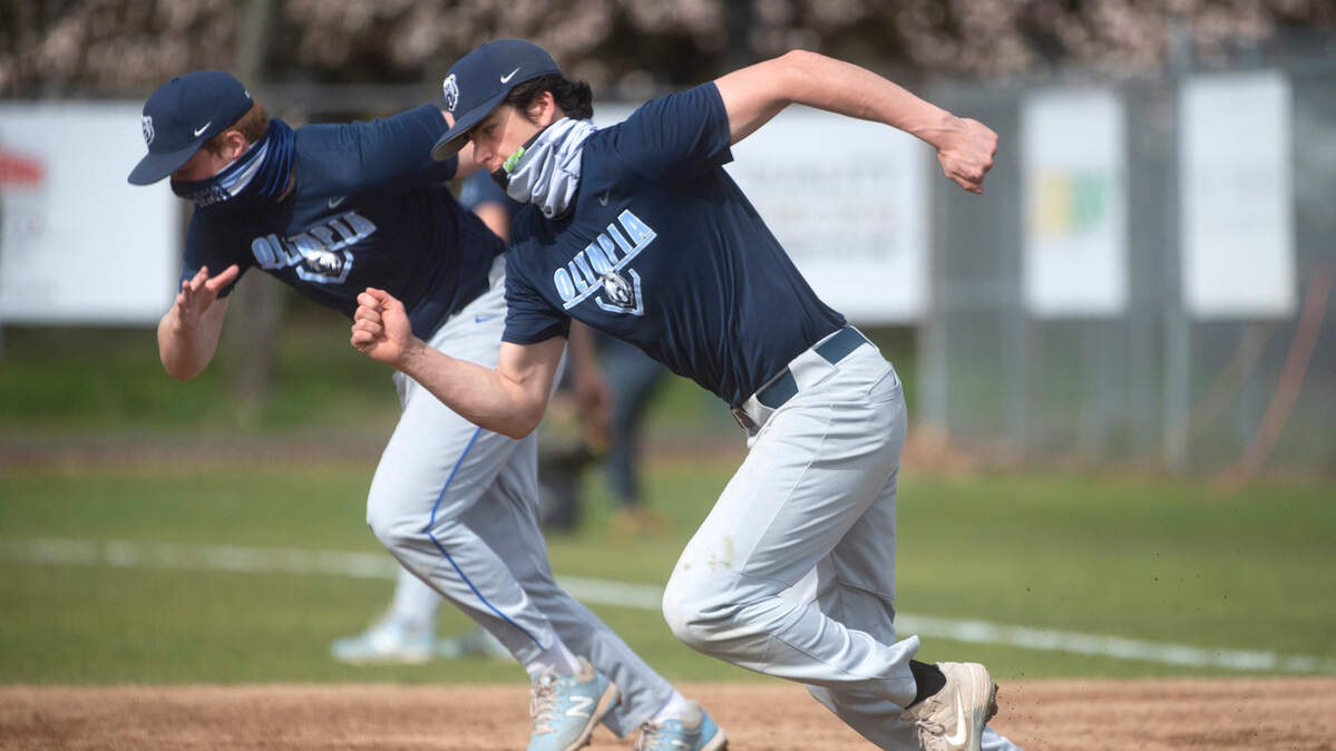 Olympia senior pitcher/infielder Aiden Herrick runs drills during baseball practice at Olympia High School on Friday, April 2, 2021.