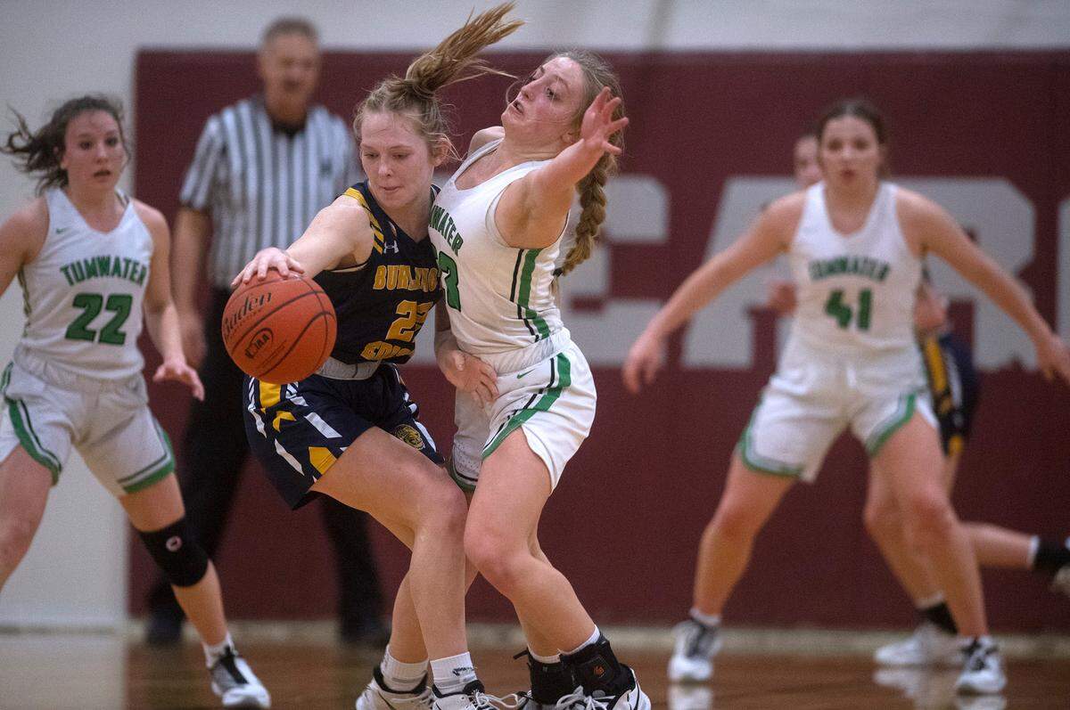 Tumwater defender Isabella Lund pressures Burlington-Edison’s Analise Slotemaker during Saturday night’s 2A girls basketball state tournament regional-round game at WF West High School in Chehalis, Washington, on Feb. 26, 2022. Burlington-Edison won the game, 52-47.