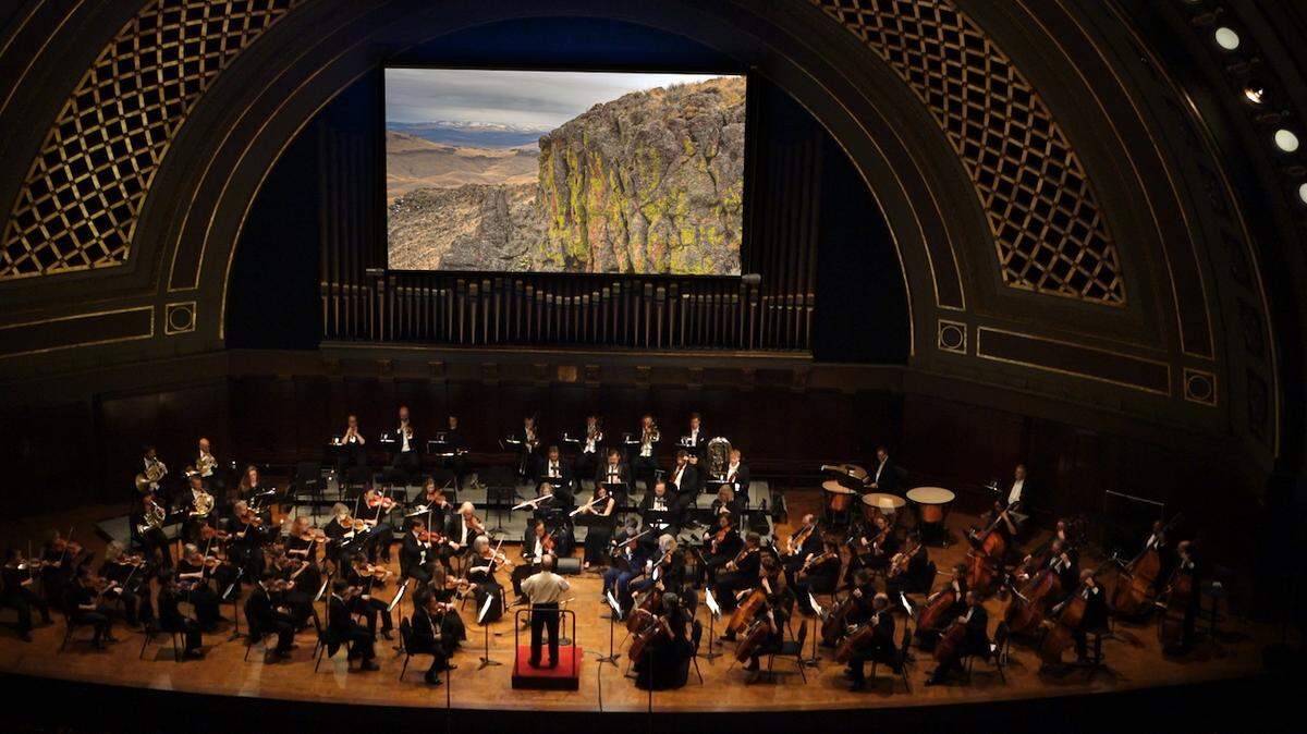 Symphony-goers will get a multi-media experience when they hear the Olympia Symphony Orchestra perform Antonín Dvořák’s Symphony No. 9 “From a New World” with a choreographed presentation of images and videos on Sunday. Seattle artist Adrian Wyard will be following conductor Huw Edwards’ cues so that the visuals, including photos by Tom Oord, will move with the music. This photo of a similar performance, with the Ann Arbor Symphony in Michigan, shows a photo by Oord above the musicians.