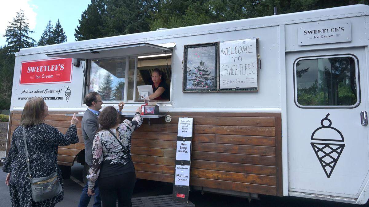 Sweetlee’s Ice Cream co-owner Lea Lee serves up ice cream on a warm Wednesday afternoon at a ribbon-cutting ceremony for the new MultiCare Capital Women’s Integrated Primary Care in west Olympia.
