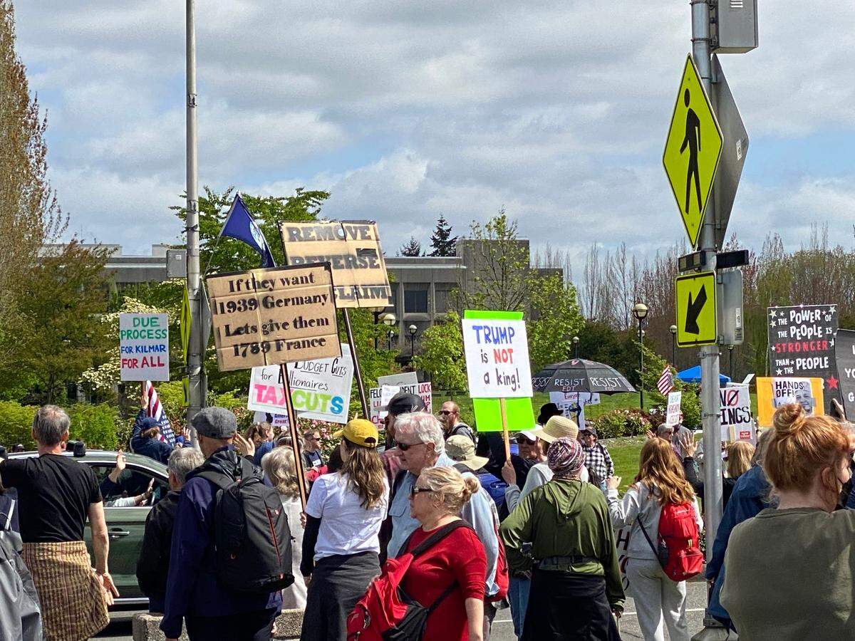 Sign-wavers get a warm greeting from a passing car on Saturday, April 19, 2025, during the protest against President Donald Trump’s actions and policies at the Washington state Capitol in Olympia.