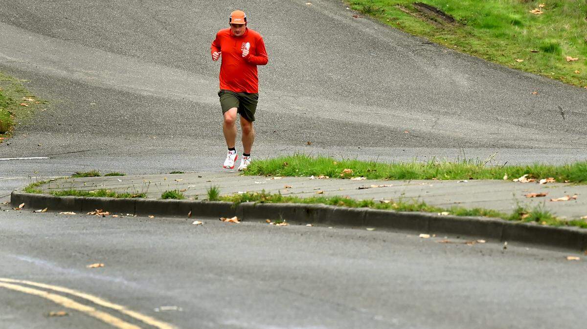 Olympia resident Mathias Eichler heads out for a run from East Bay Drive Northeast near Swantown Marina and just ahead of the rain on Nov. 1.