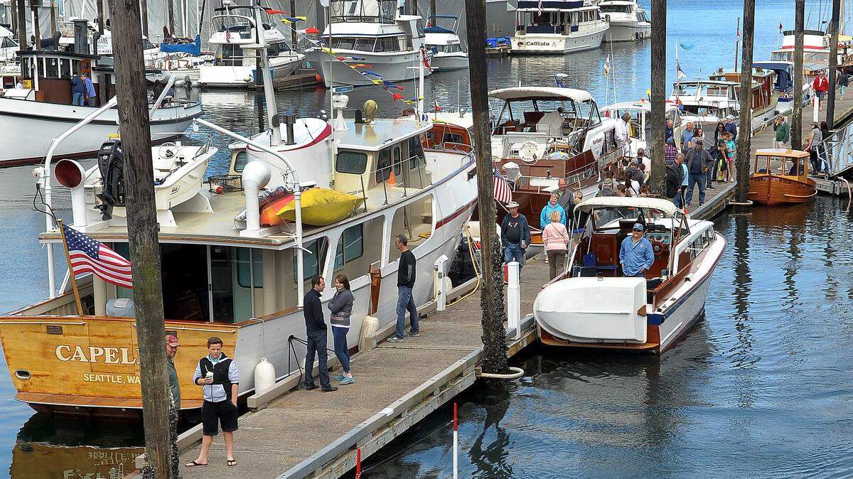Piloting his mini-tug, the 15-foot Kathy M, Robert Peck heads out for a quick show run along Percival Landing during the 2016 Wooden Boat Fair along Olympia’s Percival Landing.