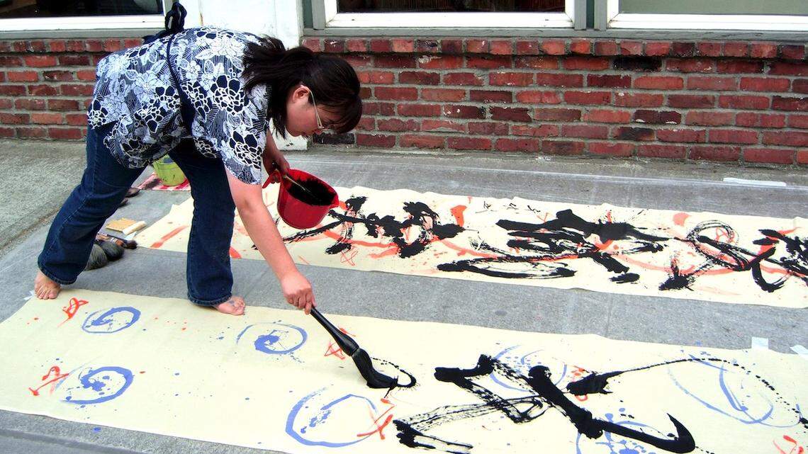 Arts Walk cover artist Chiyo Sanada, who began studying calligraphy at age 7 in her hometown of Hiroshima, Japan, puts her whole body into her work.