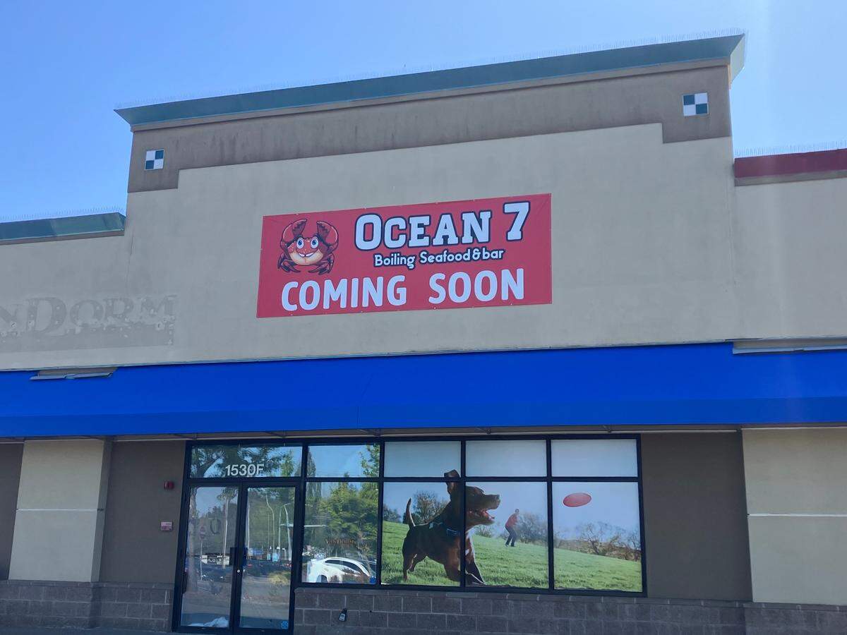 A banner hanging off a building in west Olympia announces the soon-to-open Ocean 7.