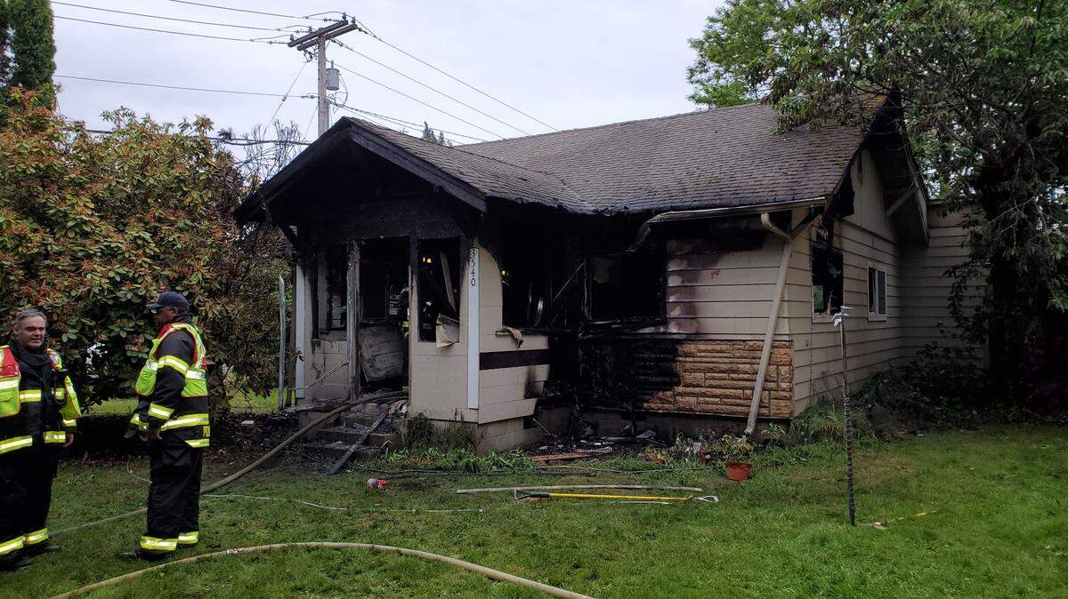Firefighters extinguish a home fire in South Bay early Friday morning.