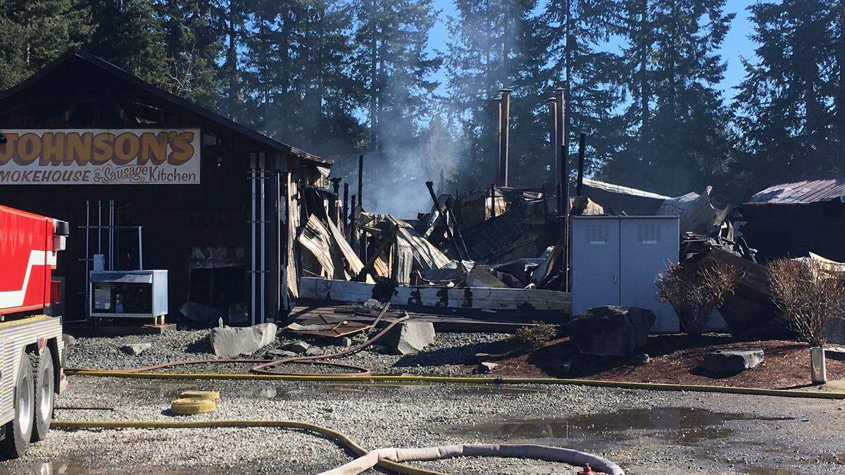 The remnants of Johnson’s Smokehouse in East Olympia after a fire destroyed the business overnight Sunday.
