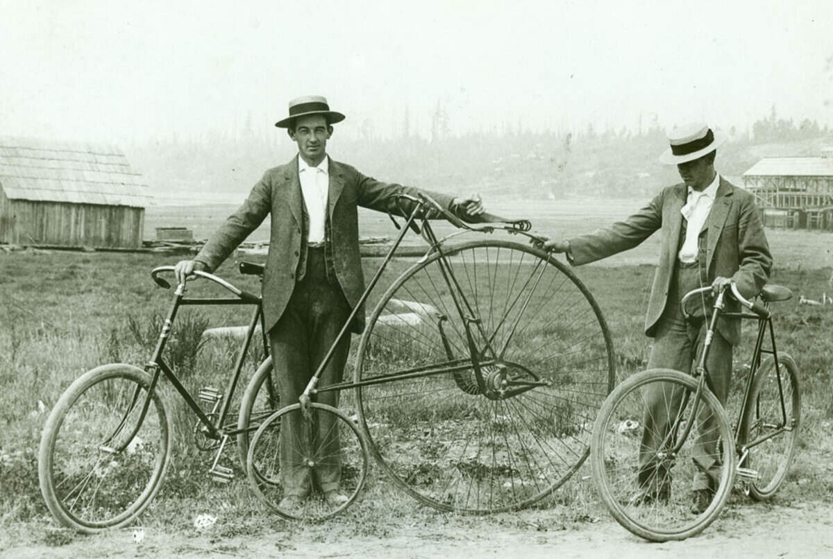 Robert Blankenship was a member of an early settler family. Along with his business partner Ed Winstanley, he operated a stationery and tobacco store in Olympia. The partnership also produced postcards featuring local scenes. Robert is pictured here with an unidentified friend and three bicycles.