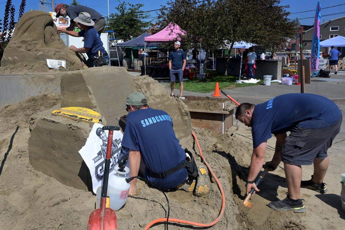 A team of sand carvers work sculpting their new artwork on Percival Plaza in Olympia during the 50th Olympia Harbor Days festival over the Labor Day weekend in 2023.