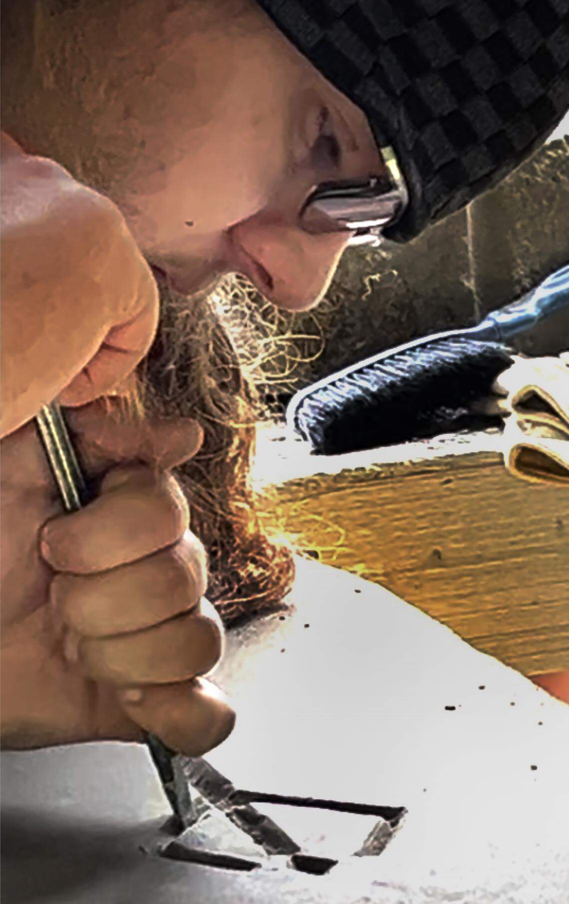 Student Evan Schiferl creates a design image on a piece of stone as part of a carving class series offered by the Tenino Stone Carvers Guild in August. 