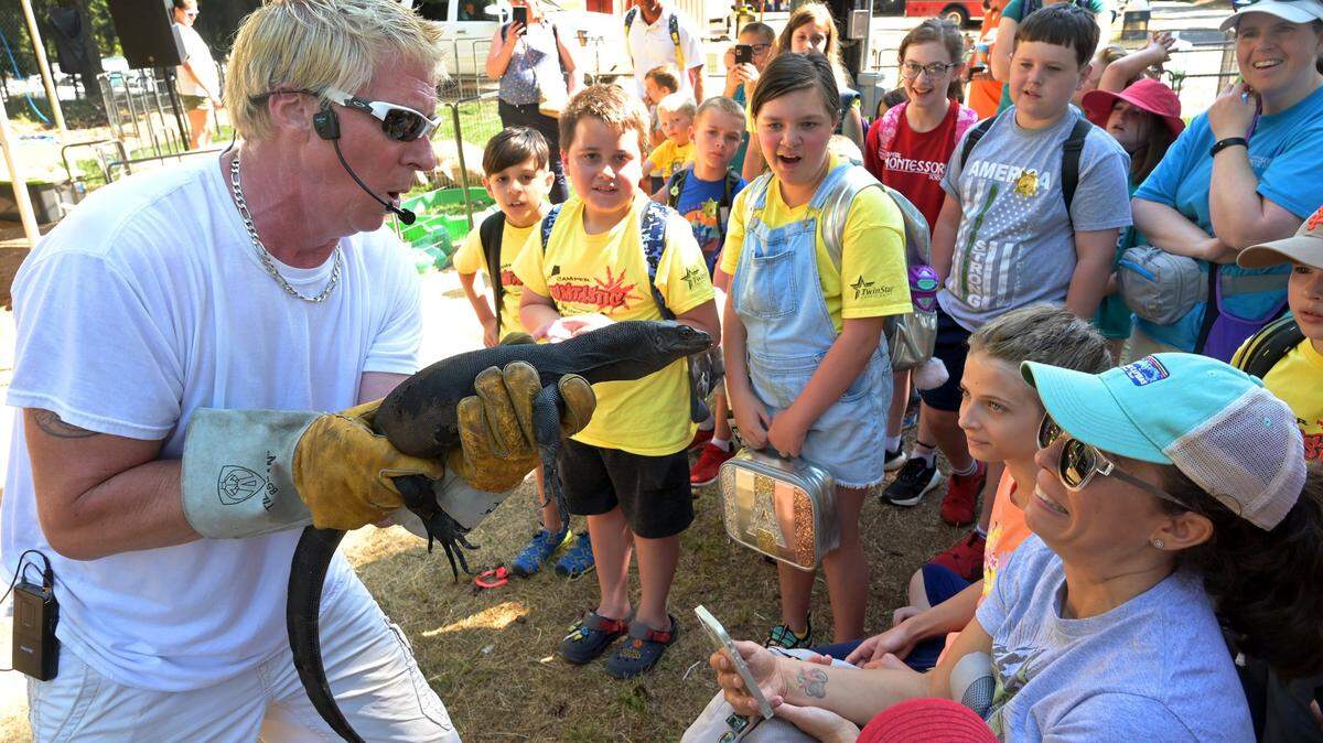 Don “The Reptile King” Riggs introduces his young Komodo dragon “Toothless” to a surprised audience on the Thurston County Fair’s 2022 opening day.