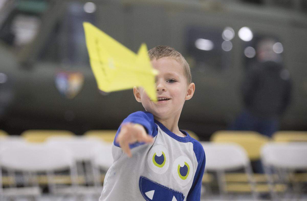 A young boy flies his aircraft during the 2017 Paper Airplane Flight School event at the Olympic Flight Museum at the Olympia Airport in Tumwater.