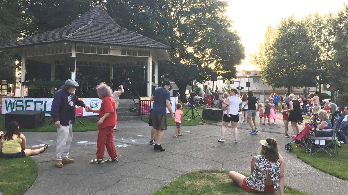 People dance and listen at a 2019 Music in the Park concert at Sylvester Park.