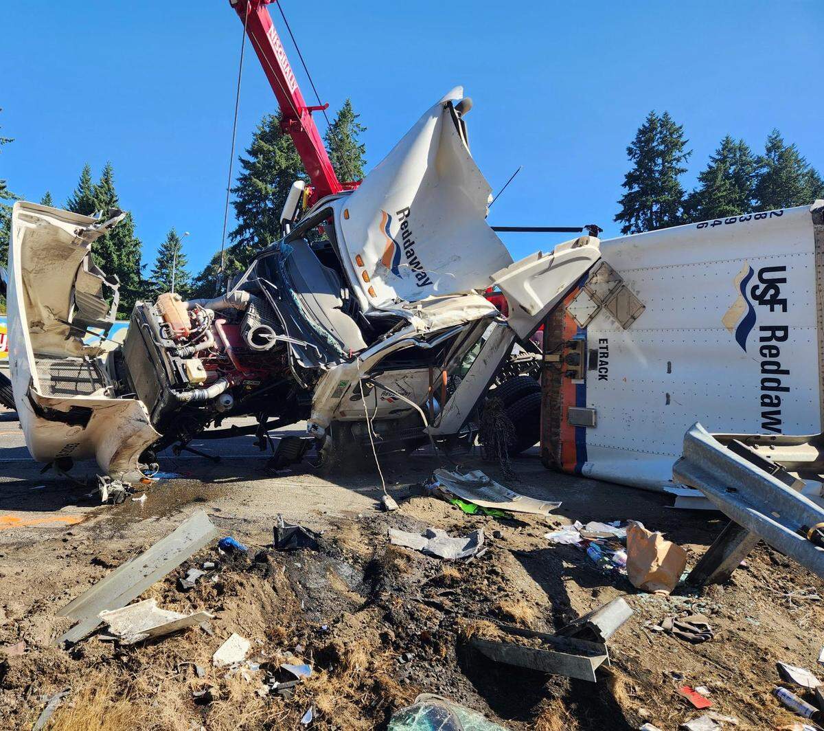 The remnants of a semi-truck vs. car crash on northbound I-5 Wednesday morning near DuPont. Here, crews continue to clear the damaged truck from the scene.