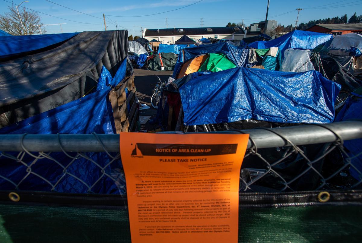A notice on the fence outside the homeless camp on State Avenue Northeast in downtown Olympia. The city says it will clear the camp Tuesday.