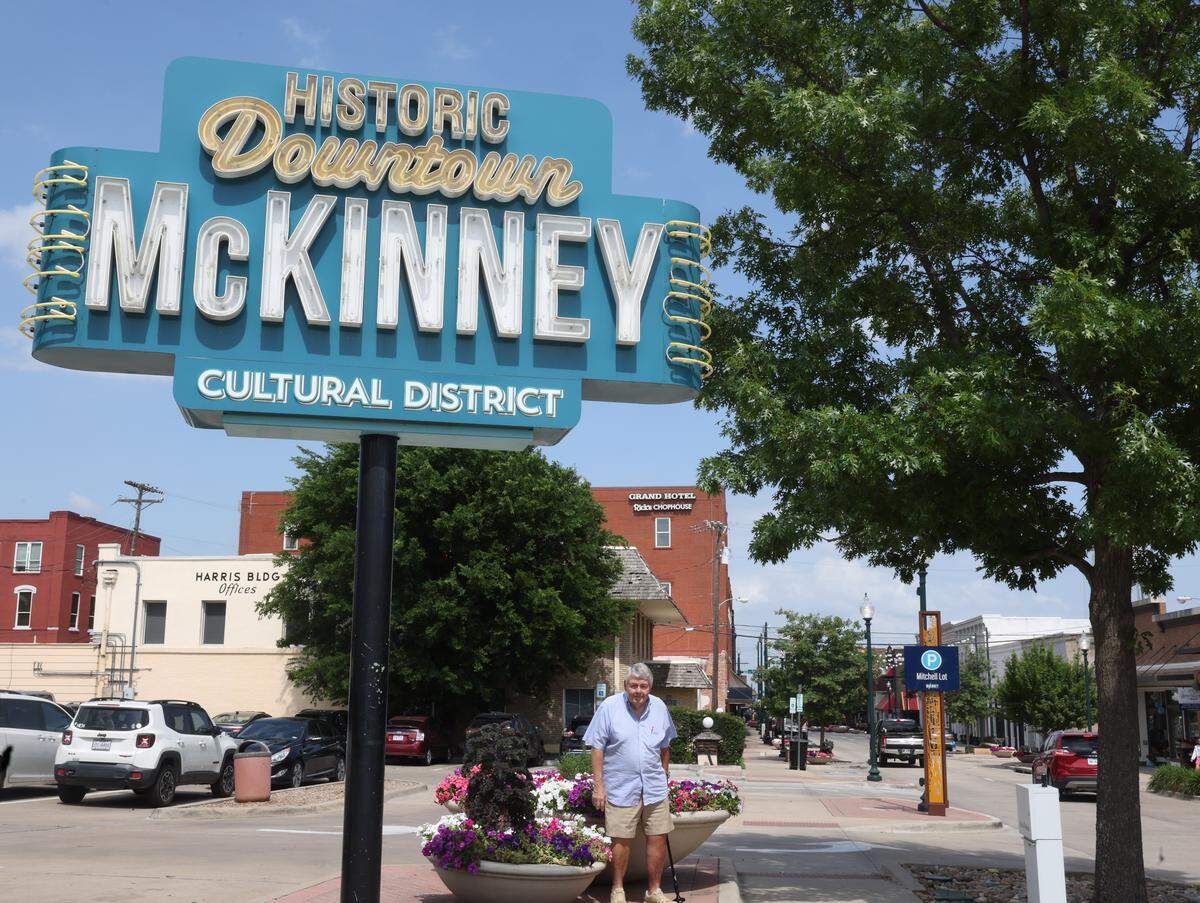 Kirby Wilbur stands near one of the entrances of the cultural district in McKinney, Texas, Monday, May, 18, 2026. Wilbur relocated to Texas from the Seattle Tacoma area.