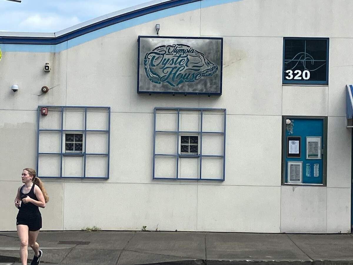 A jogger crosses the street near the Olympia Oyster House, which turned 100 this year.