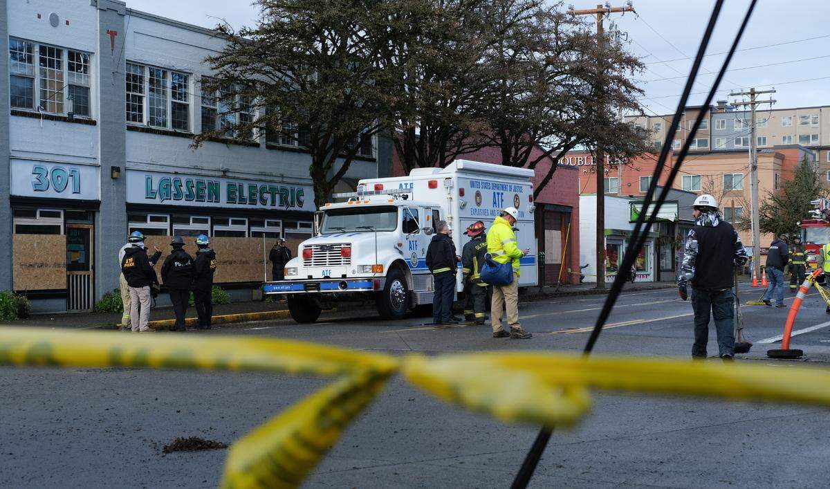 Investigators with the federal Bureau of Alcohol, Tobacco, Firearms and Explosives parked a truck in front of the the burned down apartment building on 310 Capitol Way North, Olympia on Thursday, Dec. 16, 2021. A State Patrol bomb squad truck was also on scene.