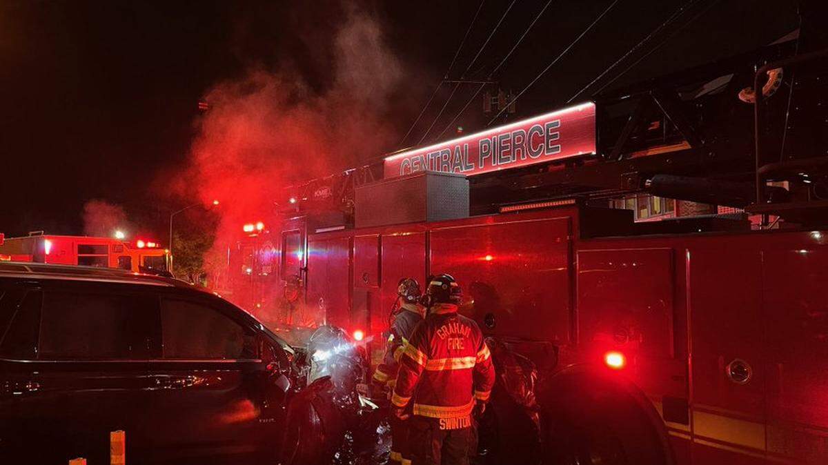 A driver struck a parked fire truck in Puyallup after crews contained a downtown garage fire overnight Sunday.