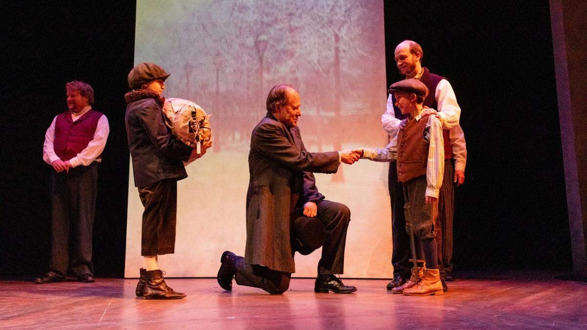 From left, Twana Beedle, Terry Edward Moore, Wade Mutchler as Tiny Tim and Nathan Rice as Bob Crachit in Harlequin Productions’ “Christmas Carol.” The theater company is offering 2-for-1 tickets after Christmas.