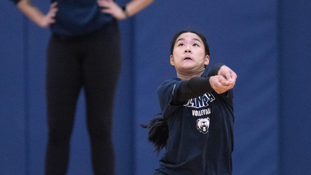 Olympia senior Ava Hoy digs a shot under the watchful eye of head coach Christie Oldright during volleyball practice at Olympia High School in Olympia, Washington, on Tuesday, Nov. 14, 2023.