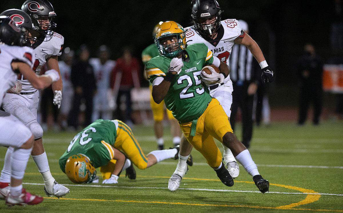 Tumwater running back Carlos Matheney turns the corner during Friday night’s high school football game against the Camas Papermakers at Tumwater District Stadium in Tumwater, Washington, on Oct. 15, 2021.