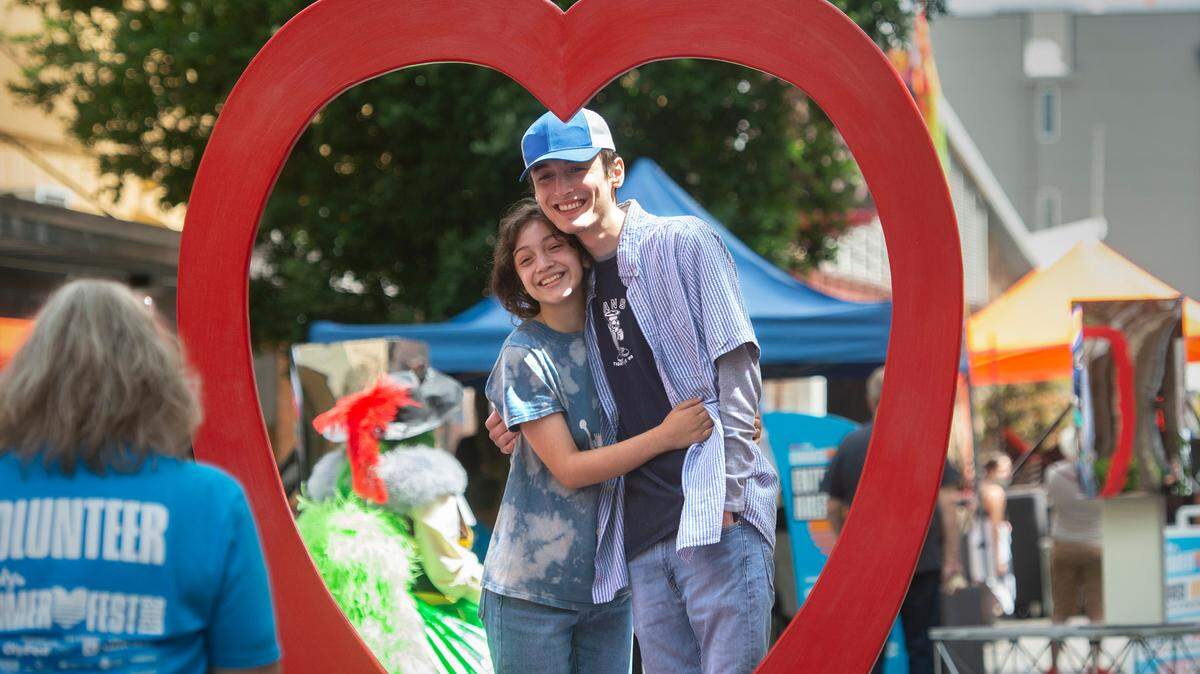 Taina Johnson (left) and Ethan Timmons, both of Olympia, get a photo taken during the inaugural LoveOly SummerFest in downtown Olympiia in 2021. The weekend festival in downtown Olympia is happening all weekend long June 21-23.
