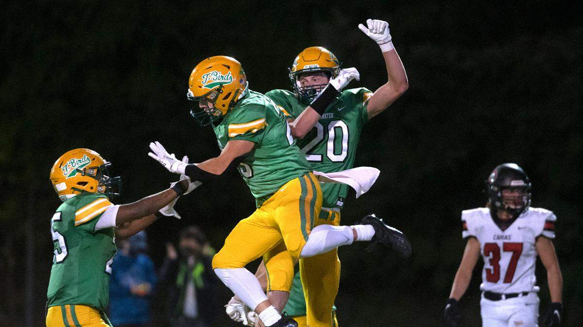 Tumwater’s Carlos Matheney (from left), Karson Schreiner and Seth Weller celebrate Weller’s touchdown reception during Friday night’s high school football game against the Camas Papermakers at Tumwater District Stadium in Tumwater, Washington, on Oct. 15, 2021.
