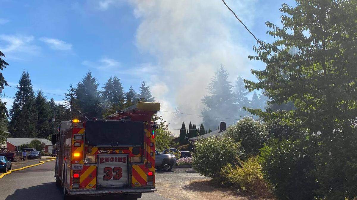 Smoke rises from a Lacey home east of Pattison Lake on Sunday.
