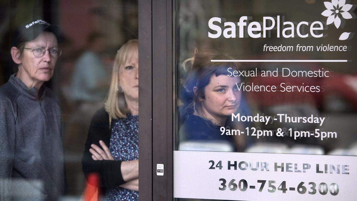 Donna Mendenhall (from left), Colleen Rice and Madison Johnson watch guests arrive for the 2015 grand opening celebration of the SafePlace Sexual and Domestic Violence Services headquarters in downtown Olympia. SafePlace is one of the primary agencies to serve domestic violence victims in Thurston County.