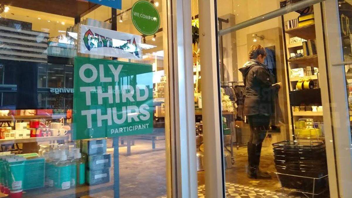 A shopper in Compass Rose on Capitol Way South, one of the businesses that participated in Third Thursday. The monthly event is ending next week after organizers say it failed to catch on.