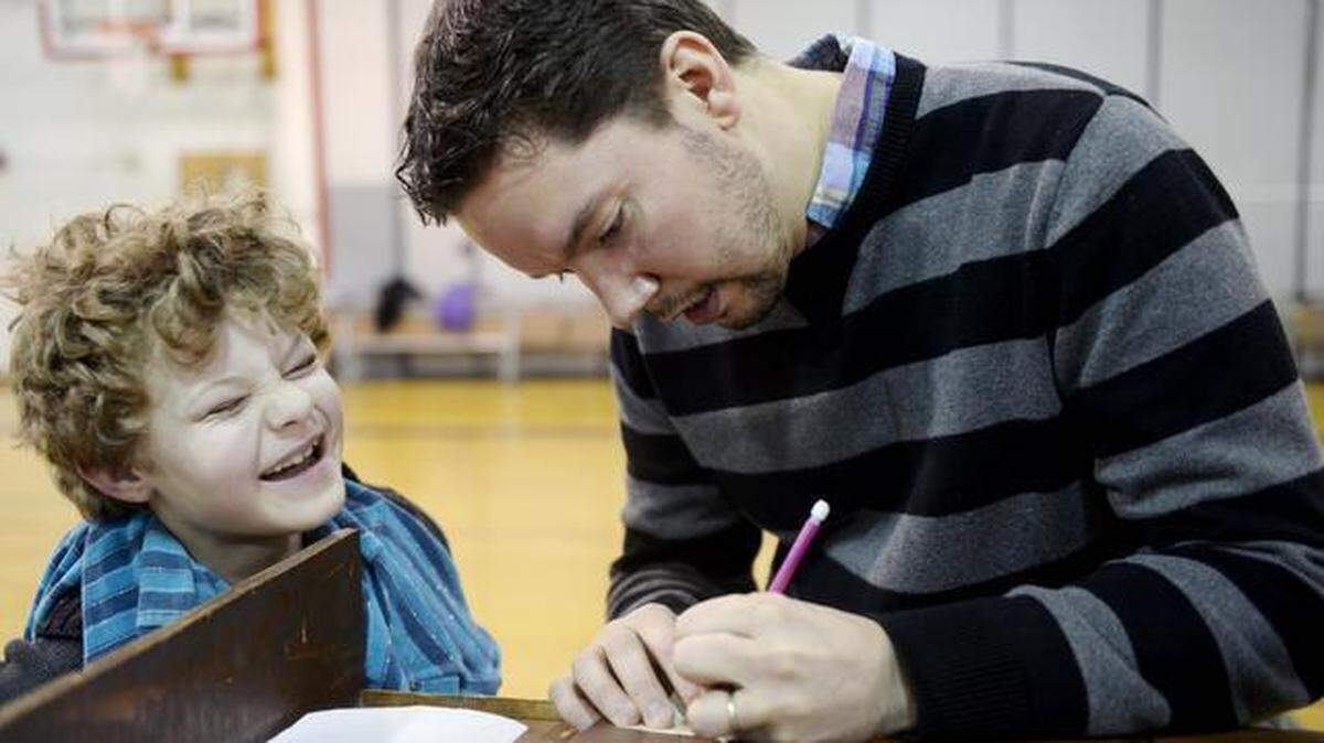 A student laughs as Ian Doescher, author of “William Shakespeare’s Star Wars,” signs a book after an assembly at Housel Middle School in Prosser in 2015.