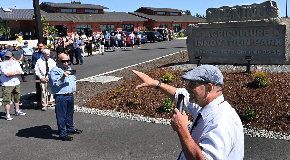 The grand opening of the new Agriculture Innovation Park in Tenino drew a large crowd of well wishers on May 29. The event featured self-guided tours and speakers and concluded with the unveiling of a multi-ton, hand-carved sign crafted out of local sandstone by Daniel Miller who addressed the crowd.
