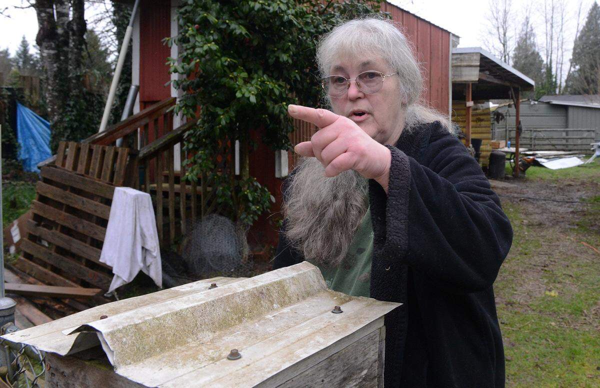 Kaye Ginter watches the NIsqually River creep up to her Sixth Avenue residence Thursday morning as she prepares to heed the evacuation advisory. “People need to stay away, because the river’s rising,” said Ginter, who is 64 and has lived at the end of Sixth Avenue for almost nine years.