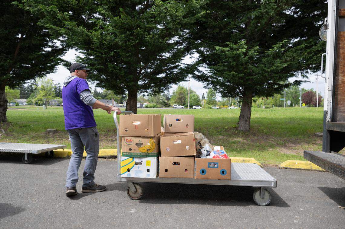 Ernie Moran, staff with Nourish, unloads a truck of donated food at the Southeast Tacoma Food Bank at Lutheran Church of Christ the King, on Wednesday, May 7, 2025, in Tacoma, Wash.