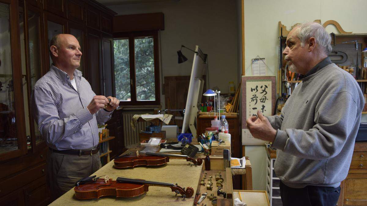 “Rosin the Bow” podcast host Joe McHugh, right, talks with violin maker Marco Picconotti in San Polo d’enza, Italy, in 2015.