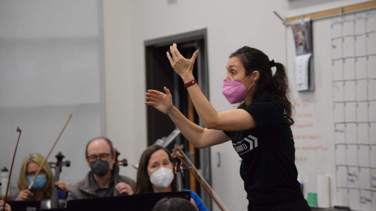 Conductor Zoe Zeniodi, one of the finalists for Olympia Symphony Orchestra’s music director position, rehearses with the orchestra. She will lead the orchestra in concert on Sunday, April 24, at the Washington Center for the Performing Arts.