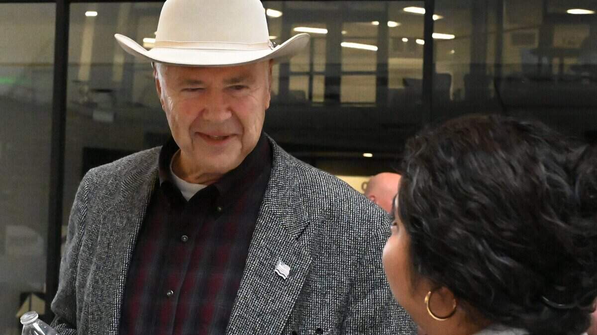 Thurston County Commissioners Gary Edwards and Carolina Mejia talk during a meet and greet public event for county manager Leonard Hernandez at the Atrium county complex in April.