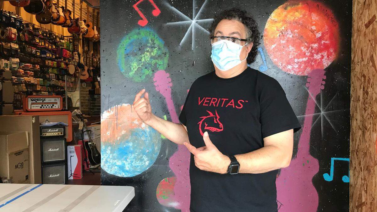When the building’s owner asked him to board up, Capital City Guitars owner Robert Johnson hired an Olympia High School student to paint a musical mural.