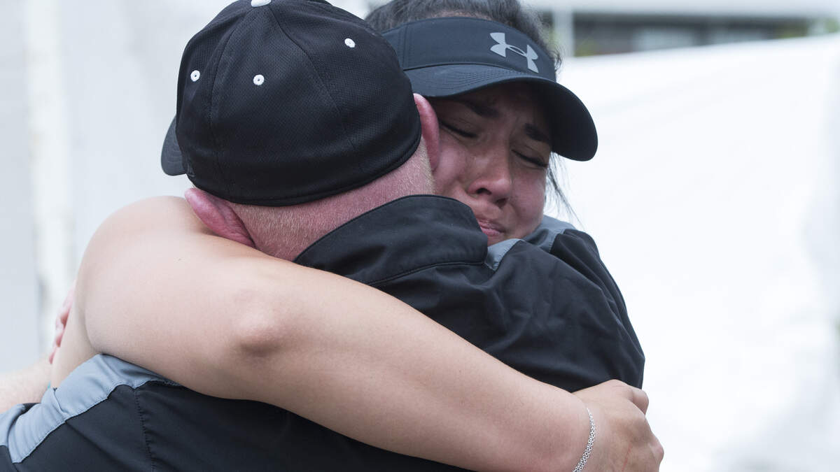 Bonney Lake's Dreakeanna Adair embraces her throws coach Jason Silbaugh after winning her third consecutive 3A discus title at the 4A/3A/2A track and field state championships at Mount Tahoma High School in Tacoma on Friday, May 25, 2018.