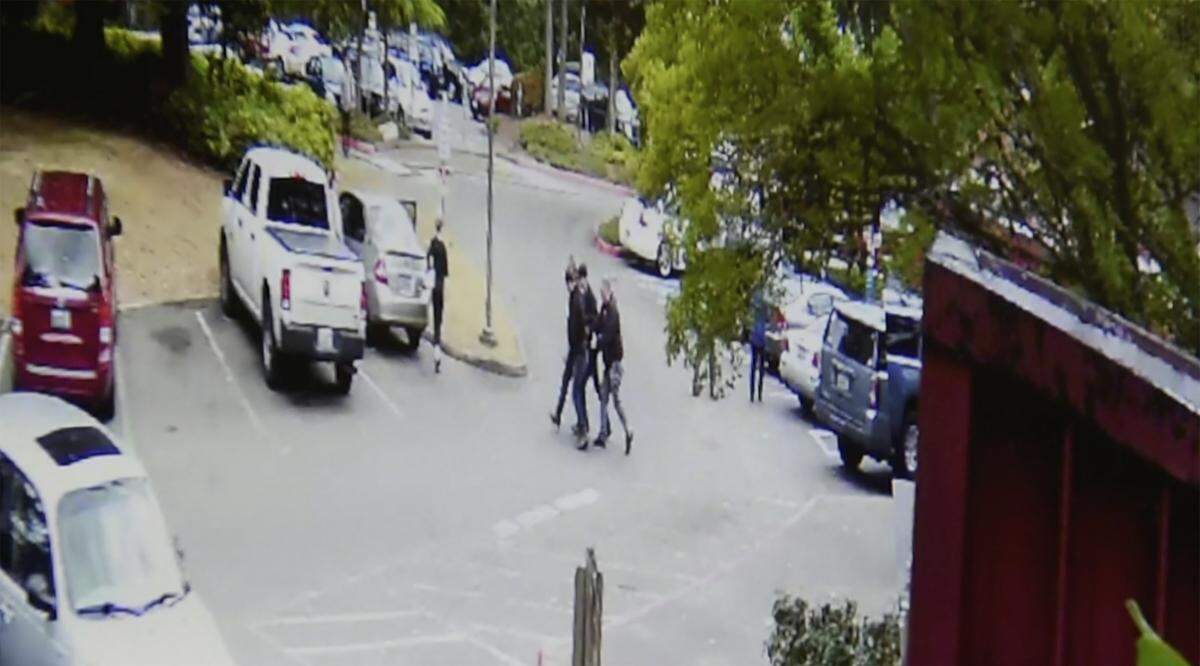 Security camera footage shows a trio of ICE agents leading away a man after arresting him outside Thurston County Superior Court in Olympia on June 20.
