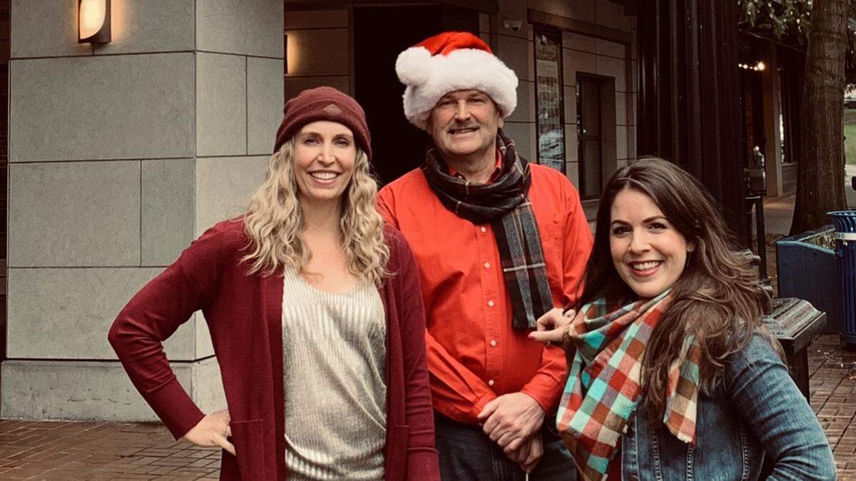 Olympia Symphony Orchestra conductor Huw Edwards is in holiday mode in preparation for Monday’s concert, which will include a sing-along led by Jill Barnes (left), executive director of The Washington Center for the Performing Arts, and Nadine Bozeman, artistic director of Olympia Youth Chorus.