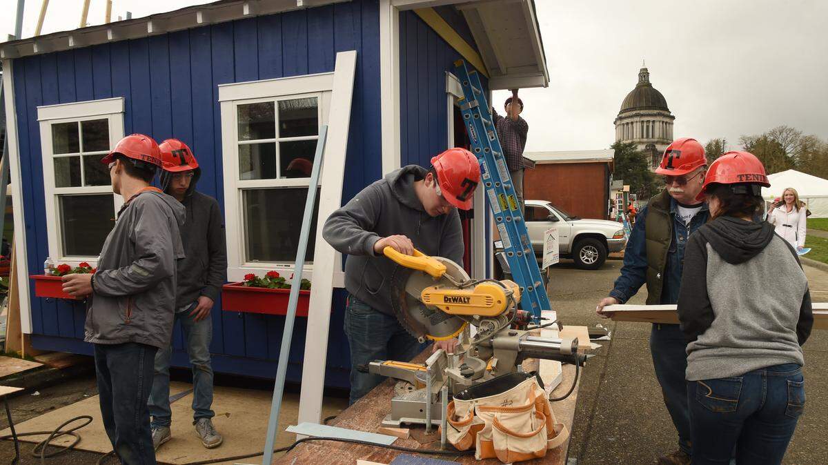 Tenino High School students build a tiny home as part of a building competition on the Capitol Campus last year.  Olympia is hoping to encourage more tiny homes -- along with duplexes, triplexes, cottages, apartments and other types of housing -- through a series of zoning changes now under review.