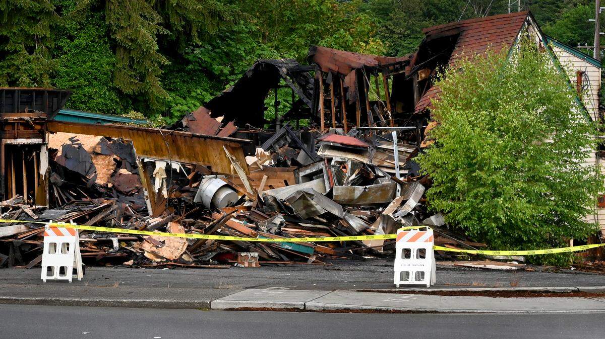 Tumwater Fire Department personnel begin sifting through the charred rubble on Monday morning that was the long-vacant South Pacific restaurant. The mid-afternoon fire had started on Sunday, June 23, with several local fire and police agencies responding.