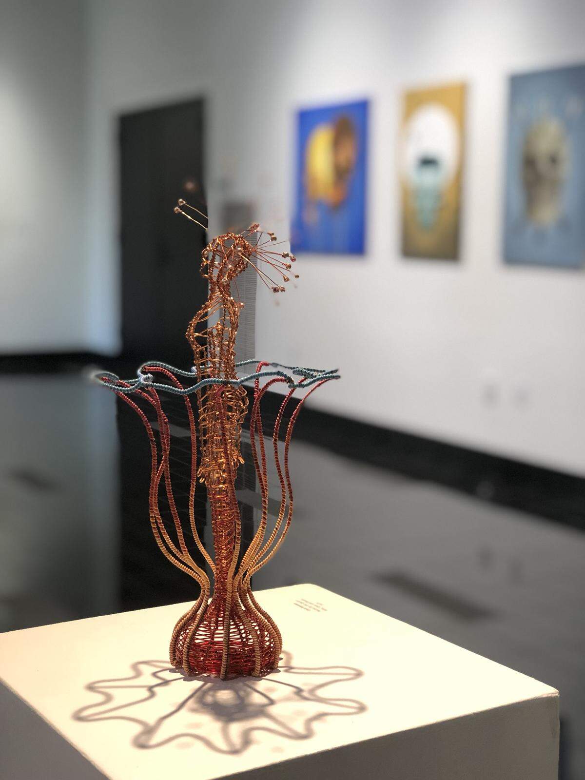 Chris Wooten’s “Flower Girl,” which is part of a larger piece called “Rain Garden.” The artist used steel, colored copper and plastic wire, as well as glass and metal beads.