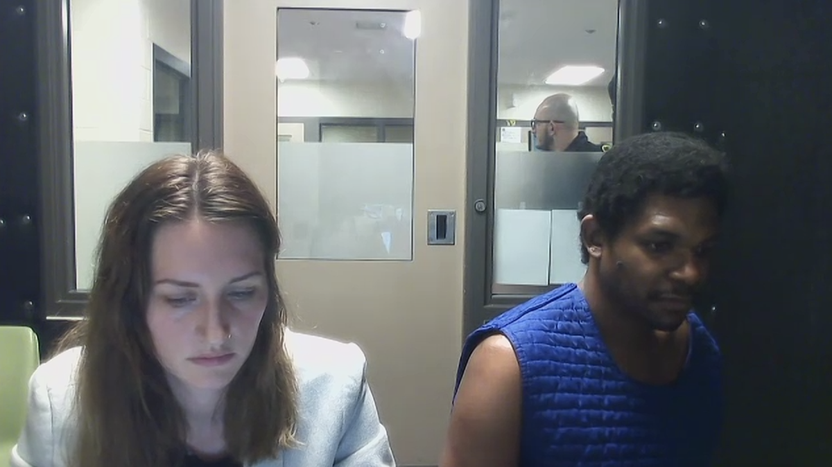 Johnathan Daniel Beacon, 37, (right) sits next to defense attorney Diana Wildland (left) in a booth at the Thurston County jail on Friday, Oct. 18, 2024. Beacon has been accused of attempting to murder his parents with sword.