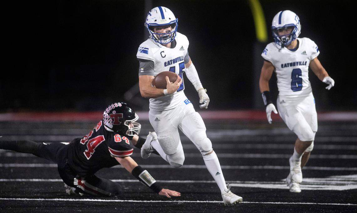 Eatonville quarterback Job Kralik breaks away from Tenino defender Michael Vasser during Friday night’s 2A football game at Tenino Beaver Stadium in Tenino, Washington, on Sept. 30, 2022. Eatonville won the game, 27-22.